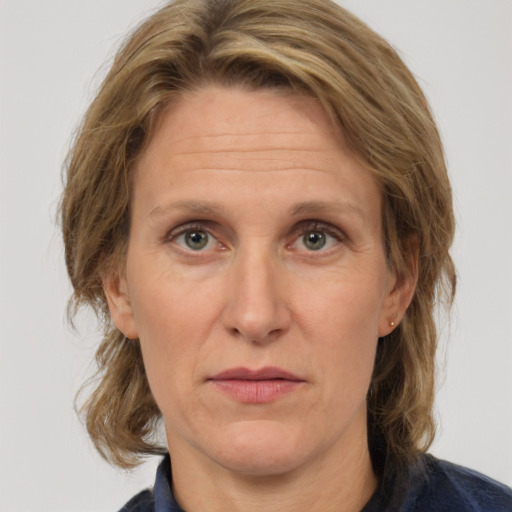 Joyful white adult female with medium  brown hair and grey eyes