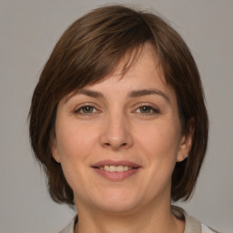 Joyful white young-adult female with medium  brown hair and grey eyes