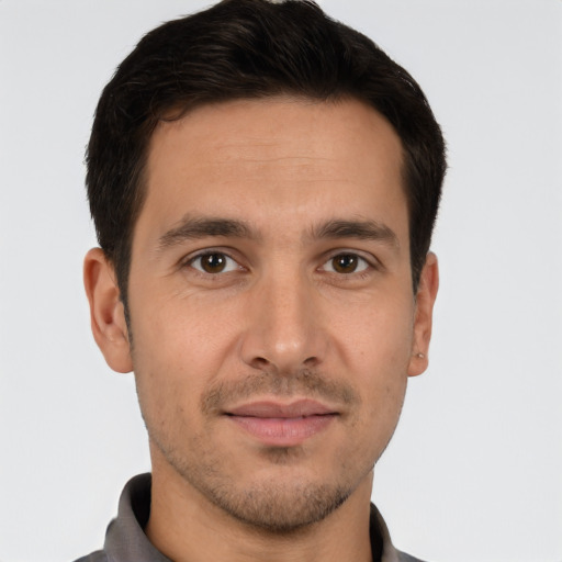 Joyful white young-adult male with short  brown hair and brown eyes