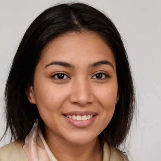 Joyful latino young-adult female with long  brown hair and brown eyes