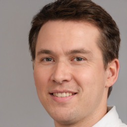 Joyful white adult male with short  brown hair and brown eyes