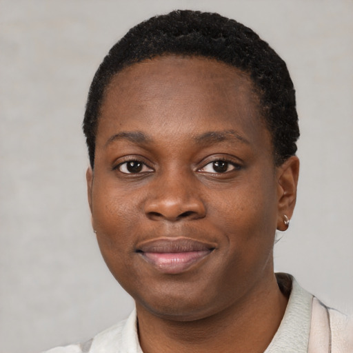 Joyful black young-adult female with short  black hair and brown eyes