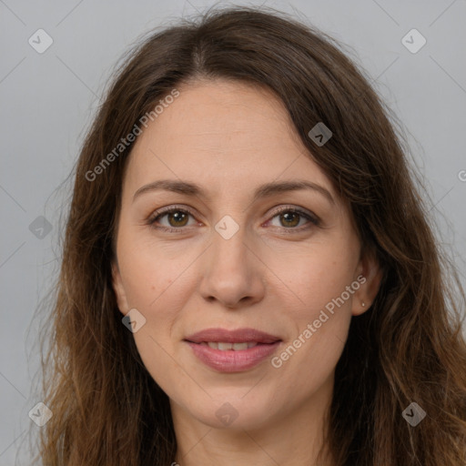 Joyful white adult female with long  brown hair and brown eyes