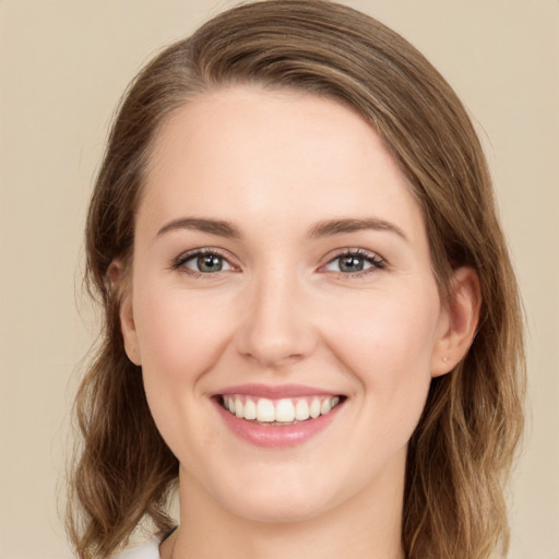 Joyful white young-adult female with medium  brown hair and green eyes