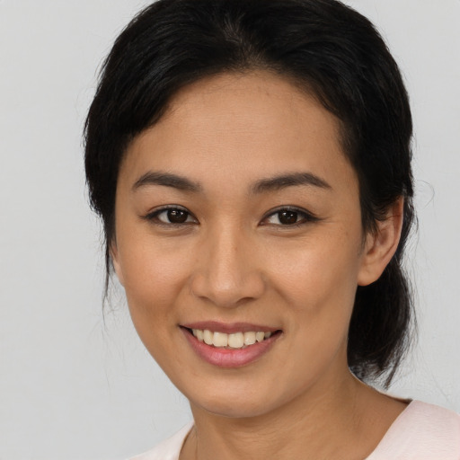 Joyful latino young-adult female with medium  black hair and brown eyes