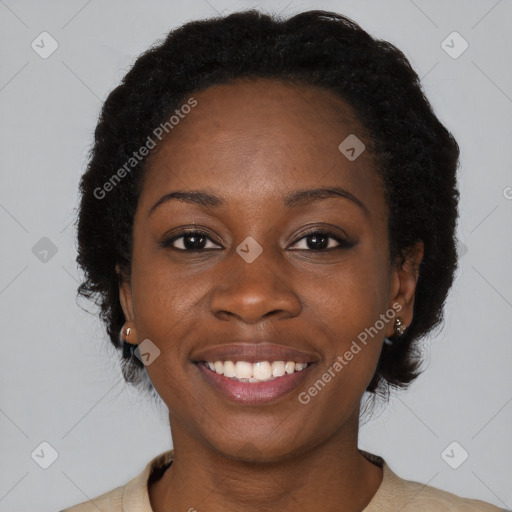 Joyful black young-adult female with short  black hair and brown eyes