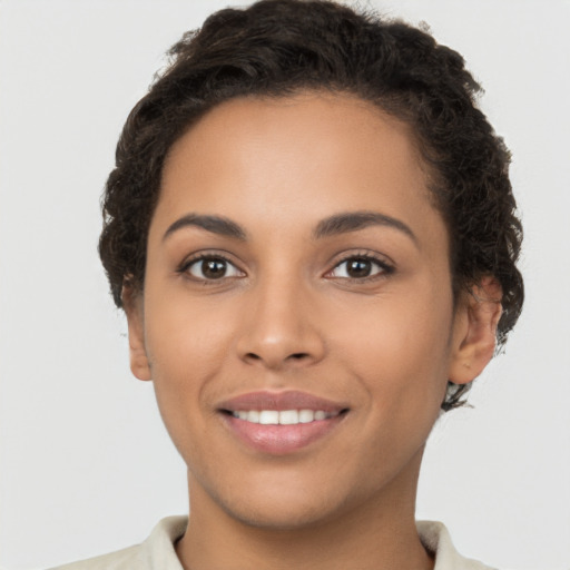 Joyful latino young-adult female with short  brown hair and brown eyes