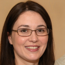 Joyful white adult female with long  brown hair and brown eyes