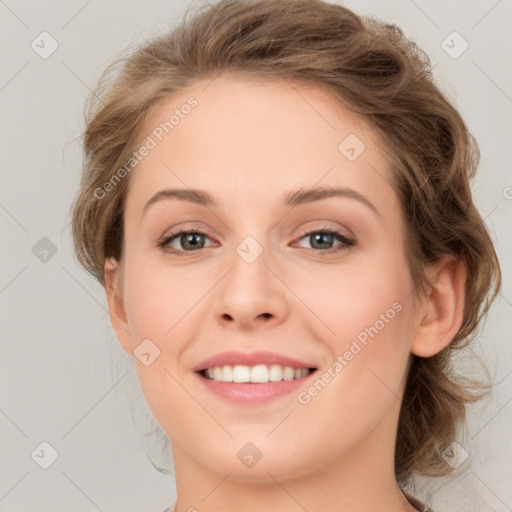 Joyful white young-adult female with medium  brown hair and green eyes