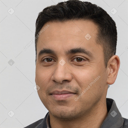 Joyful white young-adult male with short  black hair and brown eyes