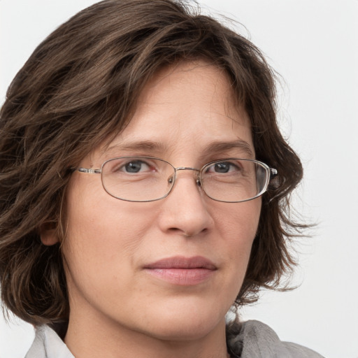 Joyful white adult female with medium  brown hair and grey eyes