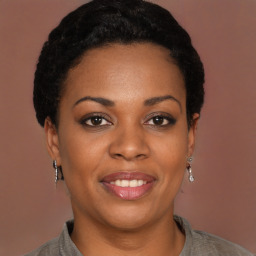 Joyful black young-adult female with short  black hair and brown eyes