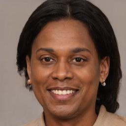 Joyful black adult female with medium  brown hair and brown eyes