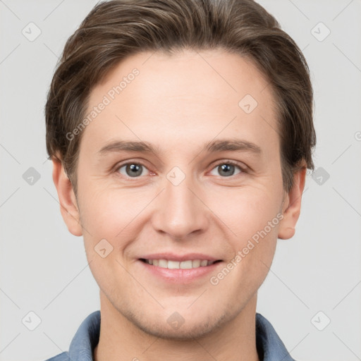 Joyful white young-adult male with short  brown hair and grey eyes