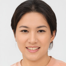 Joyful asian young-adult female with medium  brown hair and brown eyes