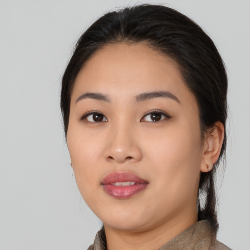 Joyful asian young-adult female with medium  black hair and brown eyes