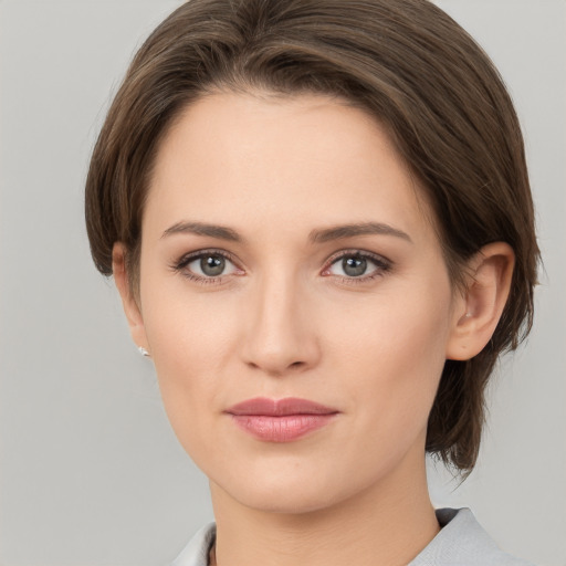 Joyful white young-adult female with medium  brown hair and grey eyes