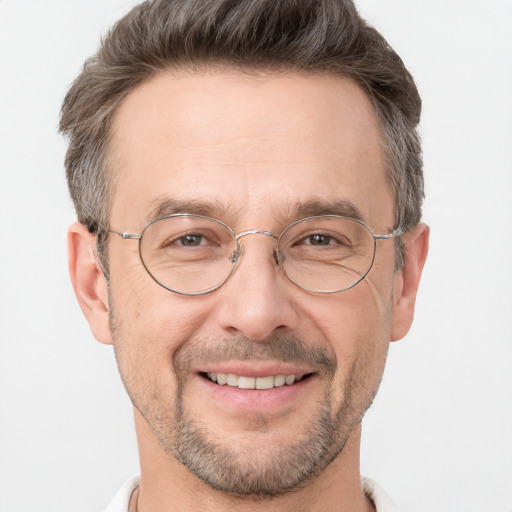 Joyful white adult male with short  brown hair and brown eyes