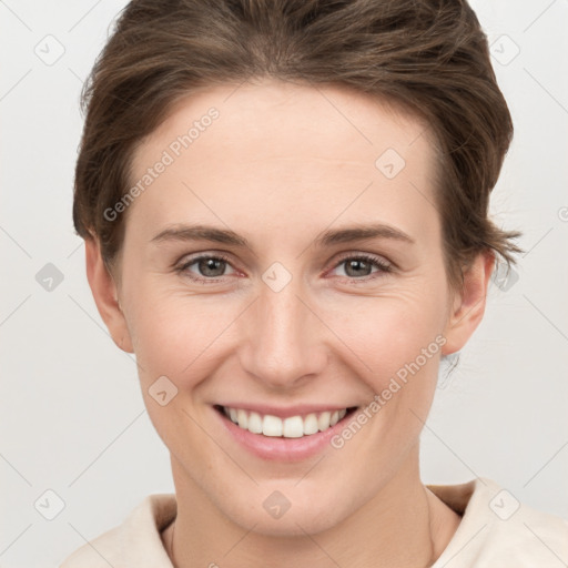 Joyful white young-adult female with short  brown hair and grey eyes