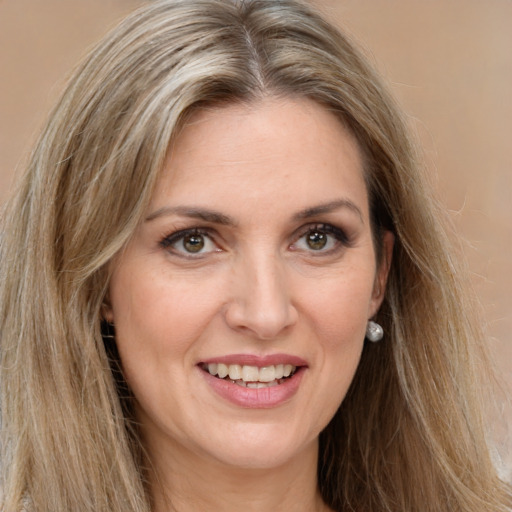 Joyful white young-adult female with long  brown hair and green eyes