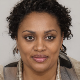 Joyful black adult female with short  brown hair and brown eyes