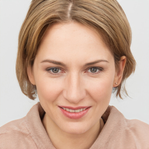 Joyful white young-adult female with medium  brown hair and grey eyes