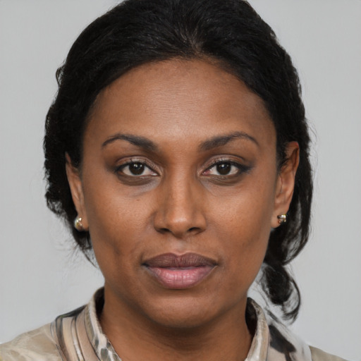 Joyful black young-adult female with medium  brown hair and brown eyes