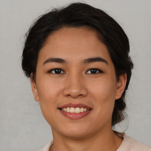 Joyful asian young-adult female with medium  black hair and brown eyes