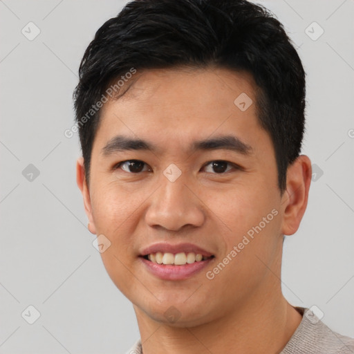 Joyful asian young-adult male with short  black hair and brown eyes