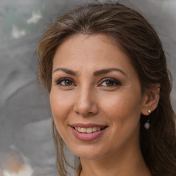 Joyful white adult female with medium  brown hair and brown eyes