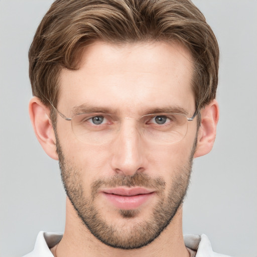 Joyful white young-adult male with short  brown hair and grey eyes