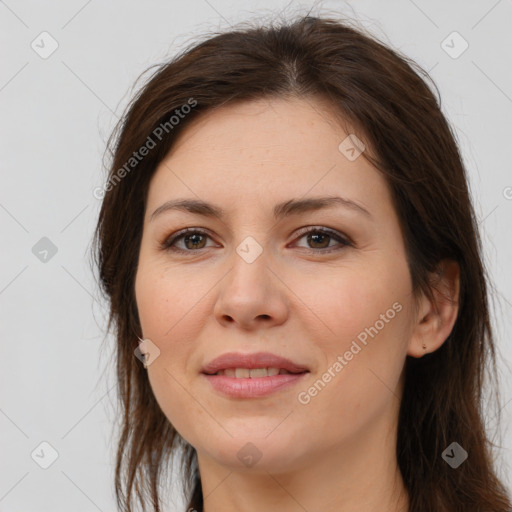 Joyful white young-adult female with long  brown hair and brown eyes