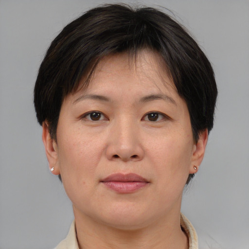 Joyful asian adult female with short  brown hair and brown eyes