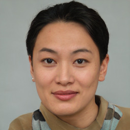 Joyful asian young-adult female with short  brown hair and brown eyes