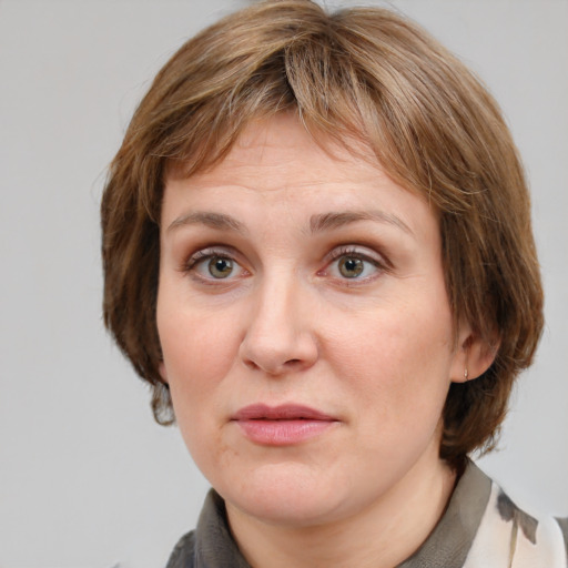 Joyful white adult female with medium  brown hair and grey eyes