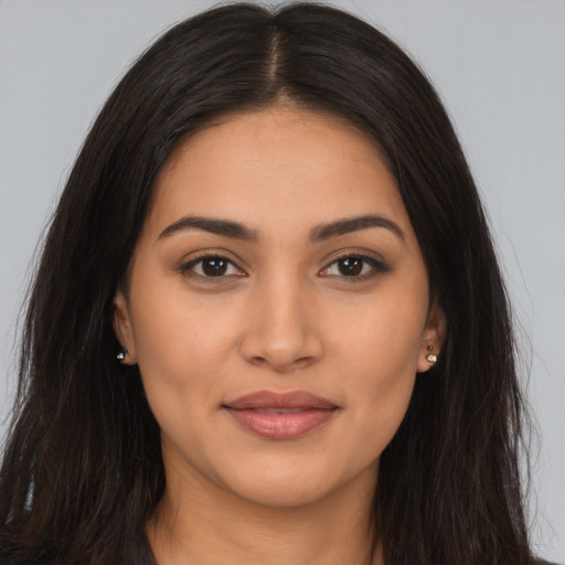 Joyful latino young-adult female with long  brown hair and brown eyes