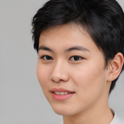 Joyful asian young-adult female with short  brown hair and brown eyes