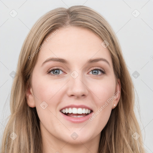 Joyful white young-adult female with long  brown hair and blue eyes