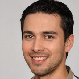 Joyful white young-adult male with short  black hair and brown eyes