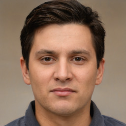 Joyful white young-adult male with short  brown hair and brown eyes