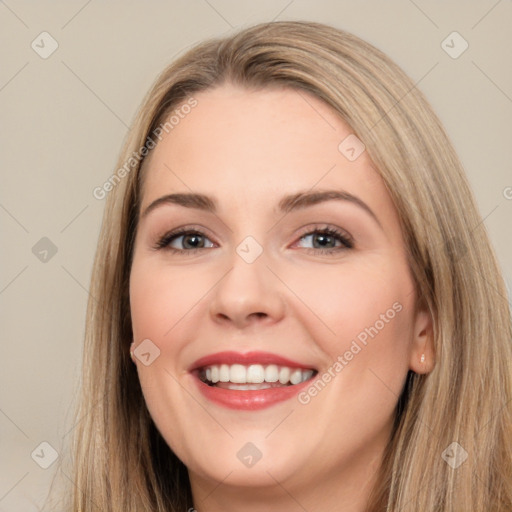 Joyful white young-adult female with long  brown hair and brown eyes