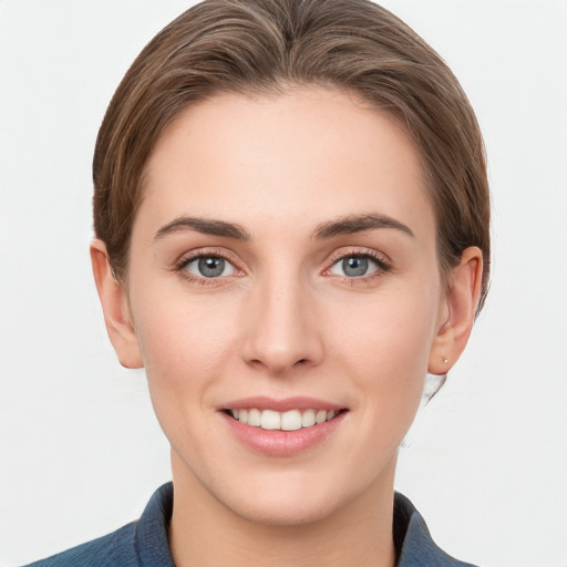 Joyful white young-adult female with short  brown hair and grey eyes