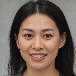 Joyful latino young-adult female with medium  brown hair and brown eyes