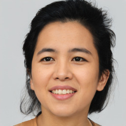 Joyful asian young-adult female with medium  black hair and brown eyes