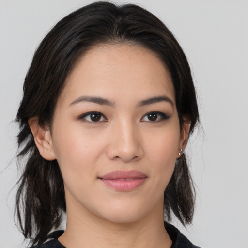 Joyful asian young-adult female with medium  brown hair and brown eyes