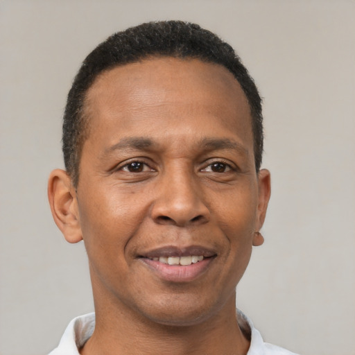 Joyful latino adult male with short  black hair and brown eyes
