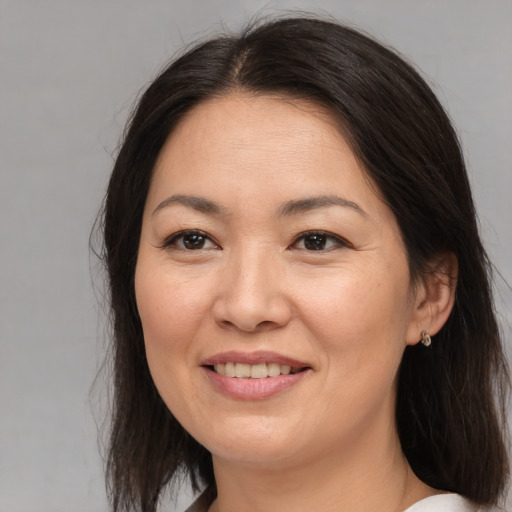 Joyful asian young-adult female with medium  brown hair and brown eyes