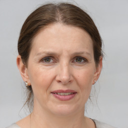 Joyful white adult female with medium  brown hair and grey eyes