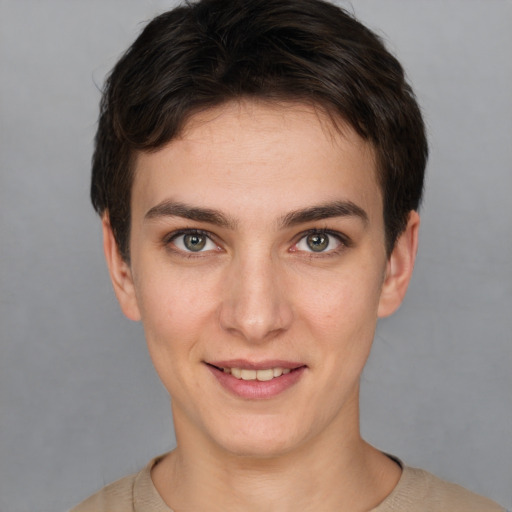 Joyful white young-adult female with short  brown hair and grey eyes