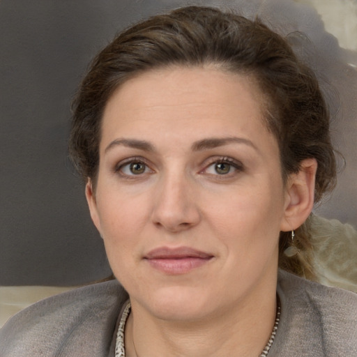 Joyful white adult female with long  brown hair and brown eyes